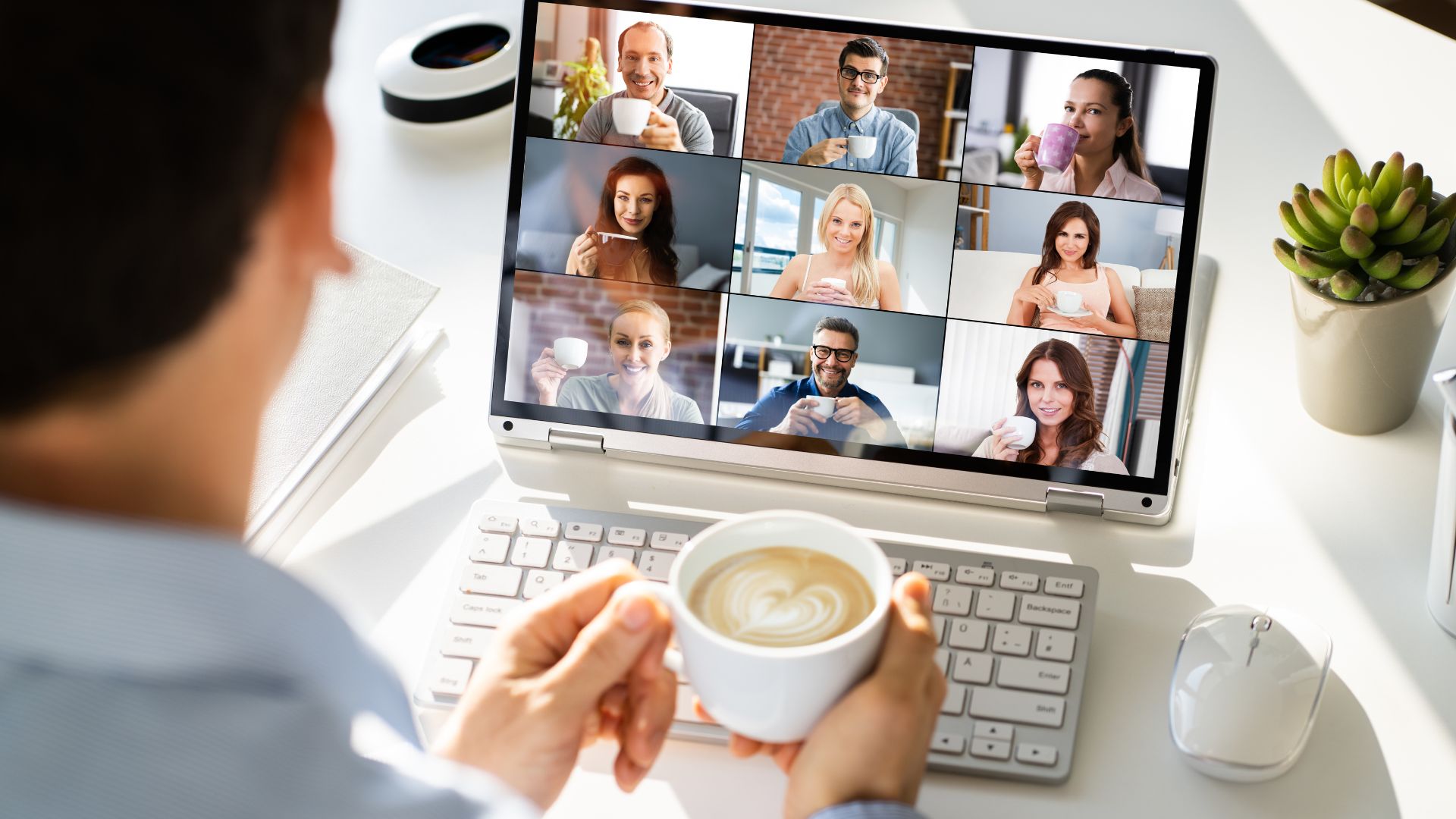 Retaining good employees: A virtual team meeting displayed on a laptop screen. 